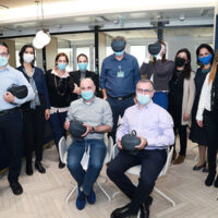 A group of Sheba employees pose with cutting edge technology