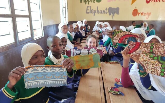 Afrikan member Shahar Kerrett works with female students to sew sanitary napkins in renovated school in Malindi, Tanzania, May 2022. (Courtesy of Afrikan)